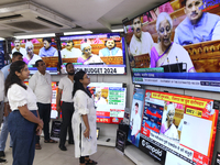 People are watching TV live as Union Finance Minister Nirmala Sitharaman addresses at an electronic shop in Kolkata, India, on July 23, 2024...