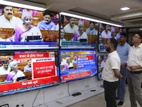 People are watching TV live as Union Finance Minister Nirmala Sitharaman addresses at an electronic shop in Kolkata, India, on July 23, 2024...