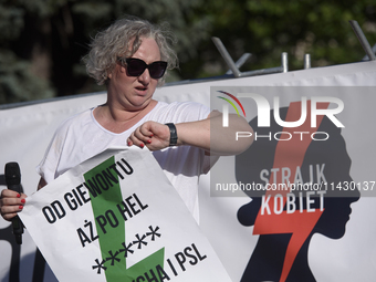 Pro-abortion activist and one of the leaders of Poland's Women Strike, Marta Lempart, is checking the time as she addresses the crowd during...