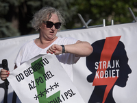 Pro-abortion activist and one of the leaders of Poland's Women Strike, Marta Lempart, is checking the time as she addresses the crowd during...