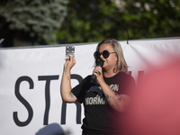 A pro-abortion activist is showing abortion pills as she addresses the crowd during a rally in favor of free and safe abortion in Warsaw, Po...