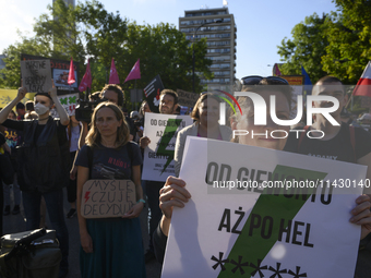 People are holding placards with Poland's Women's Strike thunder logo as they are taking part in a rally in favor of free and safe abortion...