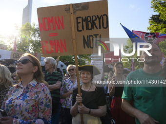 A woman is holding a sign reading ''Woman = Human Embryo not!'' as she is taking part in a rally in favour of free and safe abortion in Wars...