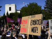 People are waving flags and holding signs as they are taking part in a rally in favor of free and safe abortion in Warsaw, Poland, on July 2...