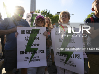 People are holding placards with Poland's Women's Strike thunder logo as they are taking part in a rally in favor of free and safe abortion...