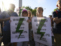 People are holding placards with Poland's Women's Strike thunder logo as they are taking part in a rally in favor of free and safe abortion...