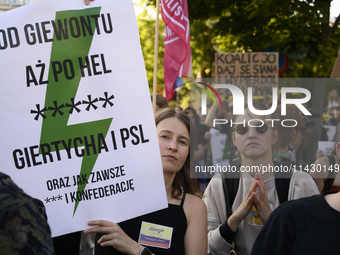 People are holding placards with Poland's Women's Strike thunder logo as they are taking part in a rally in favor of free and safe abortion...