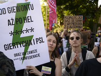 People are holding placards with Poland's Women's Strike thunder logo as they are taking part in a rally in favor of free and safe abortion...