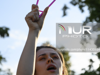 A woman is holding a cloth hanger as she is taking part in a rally in favor of free and safe abortion in Warsaw, Poland, on July 23, 2024. H...