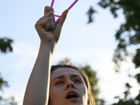 A woman is holding a cloth hanger as she is taking part in a rally in favor of free and safe abortion in Warsaw, Poland, on July 23, 2024. H...