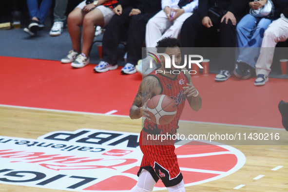 Avry Holmes #12 of Diablos Rojos is handling the ball during the National Professional Basketball League (LNBP) game between Diablos Rojos a...