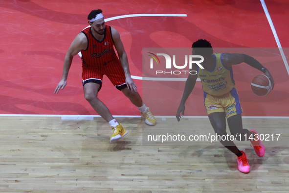 Mario Kegler #4 of Santos is driving the ball against Joseph Avila of Diablos Rojos during the National Professional Basketball League (LNBP...