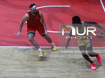 Mario Kegler #4 of Santos is driving the ball against Joseph Avila of Diablos Rojos during the National Professional Basketball League (LNBP...