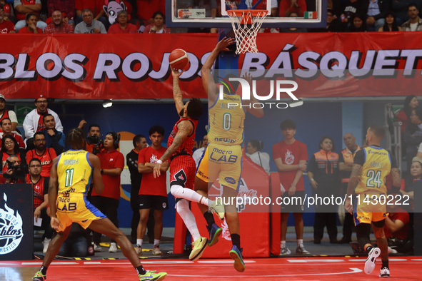 Avry Holmes #12 of Diablos Rojos is driving to the basket during the National Professional Basketball League (LNBP) game between Diablos Roj...