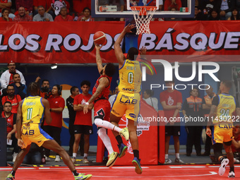 Avry Holmes #12 of Diablos Rojos is driving to the basket during the National Professional Basketball League (LNBP) game between Diablos Roj...