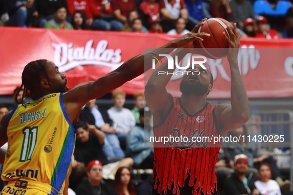 Maique Tavares #35 of the Diablos Rojos is shooting the ball against Johnny Hughes III #1 of Santos during the National Professional Basketb...