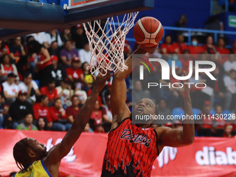 Maique Tavares #35 of Diablos Rojos is slam dunking during the National Professional Basketball League (LNBP) game between Diablos Rojos and...