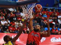 Maique Tavares #35 of Diablos Rojos is slam dunking during the National Professional Basketball League (LNBP) game between Diablos Rojos and...