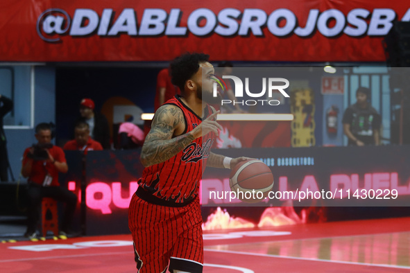 Avry Holmes #12 of Diablos Rojos is handling the ball during the National Professional Basketball League (LNBP) game between Diablos Rojos a...