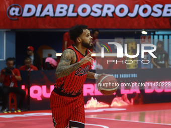 Avry Holmes #12 of Diablos Rojos is handling the ball during the National Professional Basketball League (LNBP) game between Diablos Rojos a...