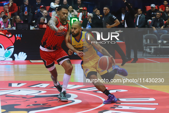 Jader Fernandez #2 of Santos is driving to the basket during the National Professional Basketball League (LNBP) game between Diablos Rojos a...