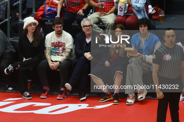 Mexican director Alfonso Cuaron is being seen during the game of the National Professional Basketball League (LNBP) between Diablos Rojos an...