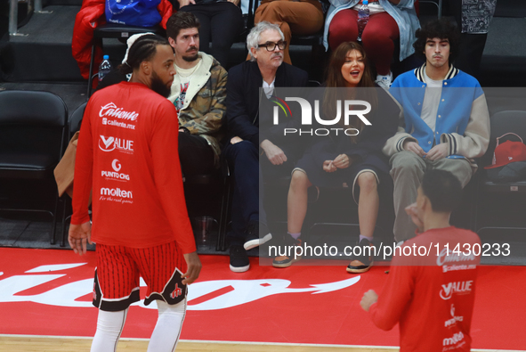 Mexican director Alfonso Cuaron is being seen during the game of the National Professional Basketball League (LNBP) between Diablos Rojos an...