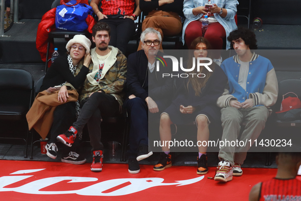 Mexican director Alfonso Cuaron is being seen during the game of the National Professional Basketball League (LNBP) between Diablos Rojos an...