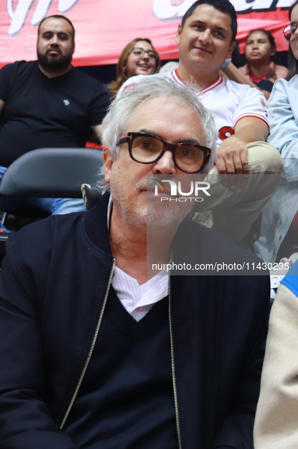 Mexican director Alfonso Cuaron is being seen during the game of the National Professional Basketball League (LNBP) between Diablos Rojos an...