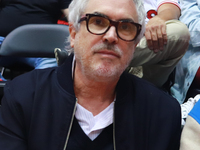 Mexican director Alfonso Cuaron is being seen during the game of the National Professional Basketball League (LNBP) between Diablos Rojos an...