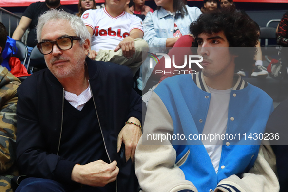 Mexican director Alfonso Cuaron is being seen during the game of the National Professional Basketball League (LNBP) between Diablos Rojos an...