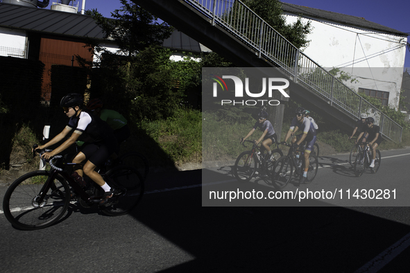 Members of the Mexican triathlon team are cycling during their training for the Paris Olympic Games in Lugo, Galicia, Spain, on July 23, 202...