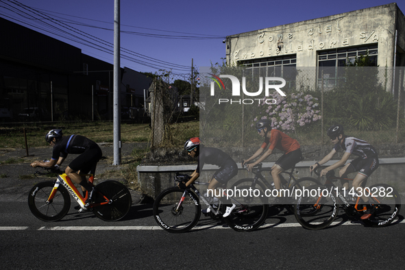 Members of the Mexican triathlon team are cycling during their training for the Paris Olympic Games in Lugo, Galicia, Spain, on July 23, 202...