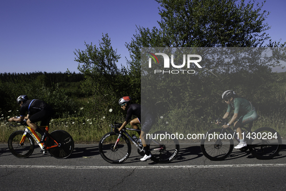 Members of the Mexican triathlon team are cycling during their training for the Paris Olympic Games in Lugo, Galicia, Spain, on July 23, 202...