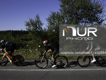 Members of the Mexican triathlon team are cycling during their training for the Paris Olympic Games in Lugo, Galicia, Spain, on July 23, 202...