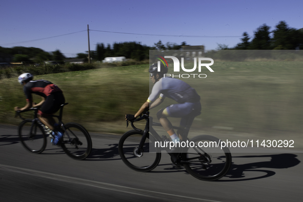 Members of the Mexican triathlon team are cycling during their training for the Paris Olympic Games in Lugo, Galicia, Spain, on July 23, 202...