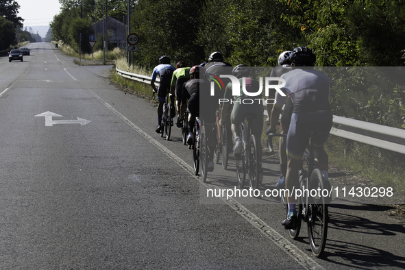 Members of the Mexican triathlon team are cycling during their training for the Paris Olympic Games in Lugo, Galicia, Spain, on July 23, 202...