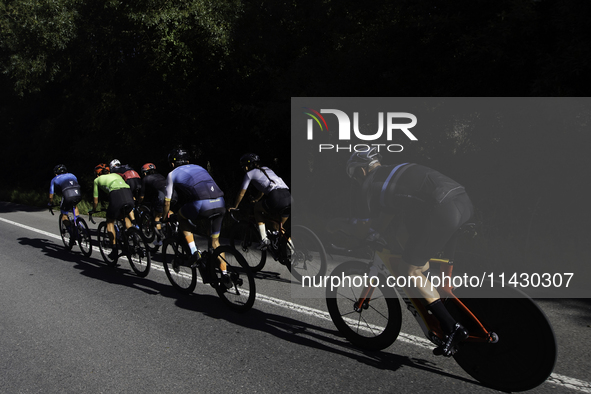 Members of the Mexican triathlon team are cycling during their training for the Paris Olympic Games in Lugo, Galicia, Spain, on July 23, 202...