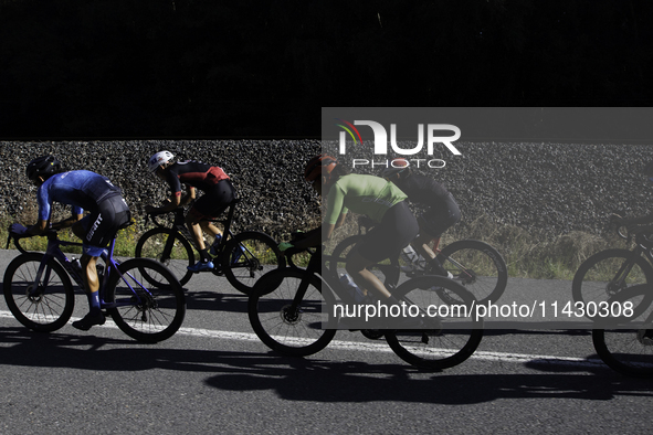 Members of the Mexican triathlon team are cycling during their training for the Paris Olympic Games in Lugo, Galicia, Spain, on July 23, 202...