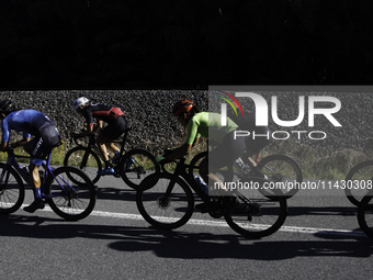 Members of the Mexican triathlon team are cycling during their training for the Paris Olympic Games in Lugo, Galicia, Spain, on July 23, 202...