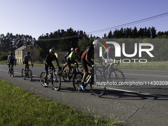 Members of the Mexican triathlon team are cycling during their training for the Paris Olympic Games in Lugo, Galicia, Spain, on July 23, 202...