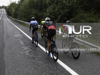 Members of the Mexican triathlon team are cycling during their training for the Paris Olympic Games in Lugo, Galicia, Spain, on July 23, 202...