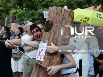 Madrid residents are demonstrating against the City Council's decision to cut down the trees in Plaza de Santa Ana to expand an underground...