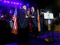 Archbishop ELPIDOPHOROS of America (L) is receiving a commemorative plaque from Supreme President SAVAS TSIVICOS (R) during the ceremony in...