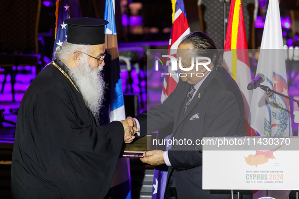 Archbishop GEORGE of Cyprus is receiving a commemorative plaque from Supreme President SAVAS TSIVICOS during the ceremony in Limassol, Cypru...