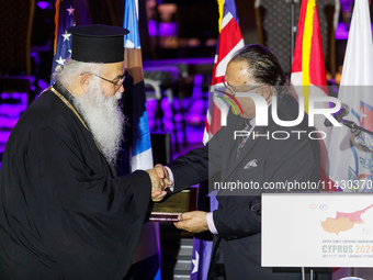 Archbishop GEORGE of Cyprus is receiving a commemorative plaque from Supreme President SAVAS TSIVICOS during the ceremony in Limassol, Cypru...