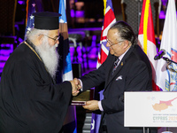 Archbishop GEORGE of Cyprus is receiving a commemorative plaque from Supreme President SAVAS TSIVICOS during the ceremony in Limassol, Cypru...