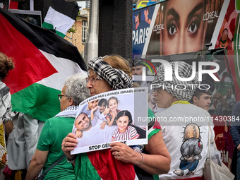 A woman is demonstrating in support of Palestine to stop the genocide of Palestinians and to exclude Israel from the Paris Olympics at the '...