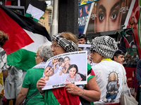 A woman is demonstrating in support of Palestine to stop the genocide of Palestinians and to exclude Israel from the Paris Olympics at the '...