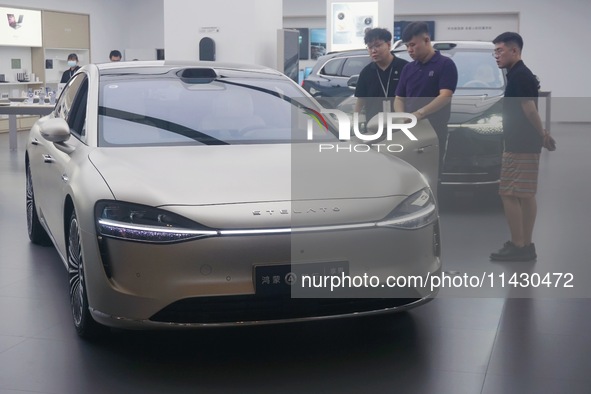 Customers are experiencing the Stelato 9, a smart luxury pure electric car, at a Huawei store in Hangzhou, China, on July 24, 2024. 